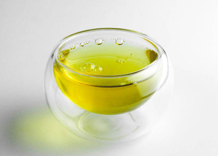 A glass of oolong tea, an eye-catching shade of light yellow-green.